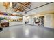 Spacious garage features ample storage space, white cabinetry, storage shelving, and a clean, gray painted floor at 2807 Coral Way, Punta Gorda, FL 33950