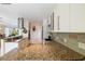Kitchen featuring granite countertops, stainless steel appliances, and tile backsplash at 2807 Coral Way, Punta Gorda, FL 33950