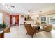 Spacious living room with a partial view of the kitchen featuring modern appliances and a seamless transition to the outdoors at 2807 Coral Way, Punta Gorda, FL 33950