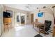 Bright living room with white floors and view to the backyard and pool at 2807 Coral Way, Punta Gorda, FL 33950