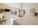 Bright main bedroom with white floors, furnishings, and sliding glass door to pool area at 2807 Coral Way, Punta Gorda, FL 33950