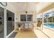 Covered patio featuring a bench and pass through window to the kitchen overlooking the pool at 2807 Coral Way, Punta Gorda, FL 33950