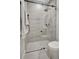 Bathroom shower encased with glass, grey tiling, with modern fixtures and rain shower head at 289 Long Meadow Ln, Rotonda West, FL 33947