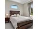 Well-lit bedroom with a wooden headboard, plush bedding, and window views for a serene atmosphere at 289 Long Meadow Ln, Rotonda West, FL 33947