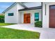 Contemporary home featuring a light-colored exterior and modern wood double-door entry at 289 Long Meadow Ln, Rotonda West, FL 33947