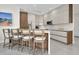 Bright kitchen with white cabinets, wood accents, a central island with bar seating, and modern appliances at 289 Long Meadow Ln, Rotonda West, FL 33947