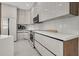 Modern kitchen with white cabinetry, quartz countertops, stainless steel appliances, and breakfast bar area at 289 Long Meadow Ln, Rotonda West, FL 33947