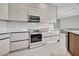 Contemporary kitchen featuring white cabinets, stainless steel range, microwave, and sleek countertops at 289 Long Meadow Ln, Rotonda West, FL 33947