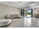 Bright and airy living room with a gray sectional sofa and access to the outdoor living space at 289 Long Meadow Ln, Rotonda West, FL 33947