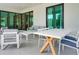 Inviting outdoor lounge area with modern furniture and a large dining table at 289 Long Meadow Ln, Rotonda West, FL 33947