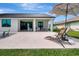 Outdoor patio with lounge chairs and dining area, great for entertaining or relaxing with Gathering and friends at 289 Long Meadow Ln, Rotonda West, FL 33947