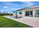 A beautiful backyard featuring a modern pool with chairs and an umbrella, perfect for relaxation and outdoor entertainment at 289 Long Meadow Ln, Rotonda West, FL 33947