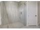 Modern, tiled walk-in shower with glass doors and rainfall shower head at 289 Long Meadow Ln, Rotonda West, FL 33947