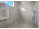 Modern, tiled walk-in shower with glass doors and rainfall shower head at 289 Long Meadow Ln, Rotonda West, FL 33947