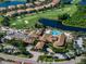 Aerial view of community clubhouse with a swimming pool and golf course at 305 Siena Vista Pl, Sun City Center, FL 33573
