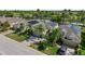 Aerial view of residences equipped with solar panels, showcasing lush landscaping and a serene neighborhood at 305 Siena Vista Pl, Sun City Center, FL 33573