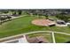 Aerial view of a baseball field with manicured green grass and community amenities at 305 Siena Vista Pl, Sun City Center, FL 33573