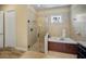 Bathroom features a glass shower, a garden tub, and tile flooring at 305 Siena Vista Pl, Sun City Center, FL 33573