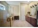 Bright bathroom with a glass shower, a soaking tub, and a double vanity with a marble countertop at 305 Siena Vista Pl, Sun City Center, FL 33573