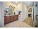 Bathroom features a double vanity and a view of a bedroom with a massage chair at 305 Siena Vista Pl, Sun City Center, FL 33573