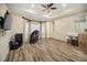 Relaxing bedroom featuring wood-look floors, a comfortable massage chair, and ample natural light at 305 Siena Vista Pl, Sun City Center, FL 33573