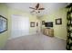 Cozy bedroom with carpeted floor, a ceiling fan, and a dresser at 305 Siena Vista Pl, Sun City Center, FL 33573