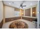 Bedroom with custom wall trim, neutral carpet, area rug and a ceiling fan at 305 Siena Vista Pl, Sun City Center, FL 33573