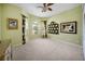 Bright bedroom with a ceiling fan, carpeted floor, and many decorations at 305 Siena Vista Pl, Sun City Center, FL 33573