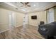 Serene bedroom with wood-look floors, a tray ceiling, and neutral tones, creating a relaxing retreat at 305 Siena Vista Pl, Sun City Center, FL 33573