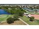 Aerial view showcases tennis and softball facilities with a nearby lake, offering a range of recreational activities at 305 Siena Vista Pl, Sun City Center, FL 33573