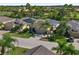 Inviting single-story home featuring solar panels, a two-car garage, and lush landscaping at 305 Siena Vista Pl, Sun City Center, FL 33573