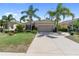 Attractive single-Gathering home with a well-manicured lawn, mature landscaping, and a two-car garage at 305 Siena Vista Pl, Sun City Center, FL 33573