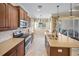 Well-appointed kitchen boasting stainless steel appliances, a large island with a sink, and stylish countertops at 305 Siena Vista Pl, Sun City Center, FL 33573