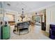 Open-concept living space featuring a piano, neutral decor, and tile flooring with access to the lanai at 305 Siena Vista Pl, Sun City Center, FL 33573