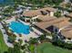 Aerial view of community pool, deck with lounge chairs, and putting green at clubhouse at 305 Siena Vista Pl, Sun City Center, FL 33573