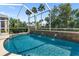 A beautiful screened-in pool features three elegant water fountains, providing a luxurious outdoor retreat at 305 Siena Vista Pl, Sun City Center, FL 33573