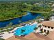 Aerial view of a community pool with lounge chairs and community buildings at 305 Siena Vista Pl, Sun City Center, FL 33573