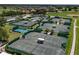Aerial view of multiple well-maintained tennis courts surrounded by lush landscaping in a vibrant community at 305 Siena Vista Pl, Sun City Center, FL 33573