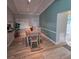 Dining room with wood-look floors, dining table with seating for six, adjacent to an updated bathroom at 3727 Dover Dr, Sarasota, FL 34235