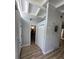 Bright hallway featuring wood-look flooring, coat closet, accent wall, and skylight offering natural light at 3727 Dover Dr, Sarasota, FL 34235