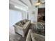 Open living room showcasing wood floors, a sliding glass door, and comfortable seating at 3727 Dover Dr, Sarasota, FL 34235