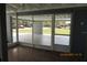 Enclosed patio with view of the front yard and residential street beyond at 3727 Dover Dr, Sarasota, FL 34235