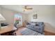 Cozy bedroom with a ceiling fan, a comfortable sofa, and natural light at 4198 Vallarta Ct # 3027, Sarasota, FL 34233