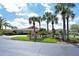 Community clubhouse with lush landscaping and palm trees at 4198 Vallarta Ct # 3027, Sarasota, FL 34233