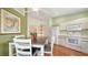 Bright dining area featuring hardwood floors and connecting kitchen with modern appliances at 4198 Vallarta Ct # 3027, Sarasota, FL 34233