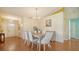 Elegant dining room with hardwood floors, chandelier, and stylish furniture at 4198 Vallarta Ct # 3027, Sarasota, FL 34233