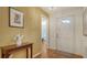 Welcoming foyer with hardwood floors, a console table, and a bright front door at 4198 Vallarta Ct # 3027, Sarasota, FL 34233