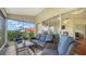 Comfortable lanai with wicker furniture, screened windows and a view of the lush exterior at 4198 Vallarta Ct # 3027, Sarasota, FL 34233