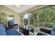 Relaxing screened-in lanai with wicker furniture and sliding glass doors to the home's interior at 4198 Vallarta Ct # 3027, Sarasota, FL 34233