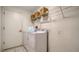 Clean laundry room with washer, dryer, shelving, and tile floors at 4198 Vallarta Ct # 3027, Sarasota, FL 34233